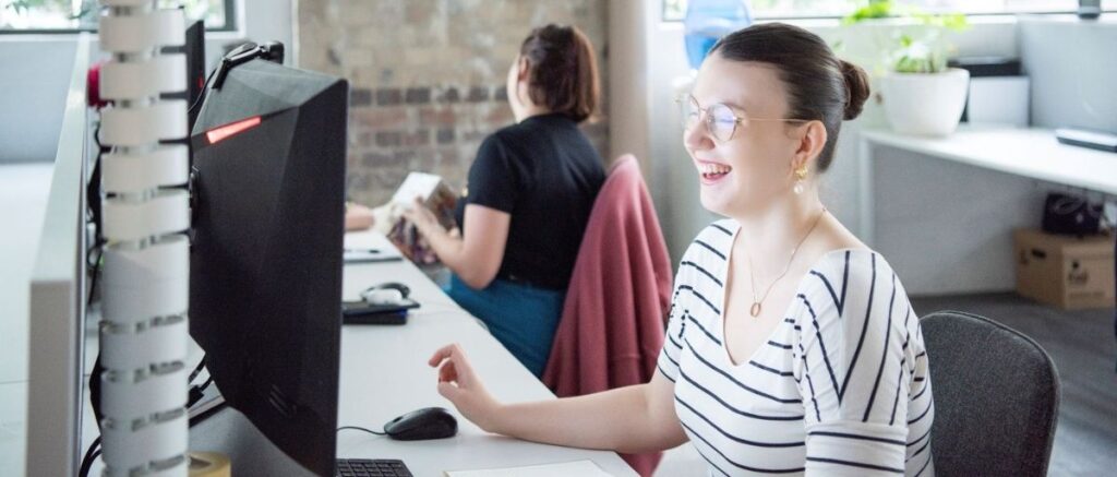 Julia SEO Strategist looking at computer laughing